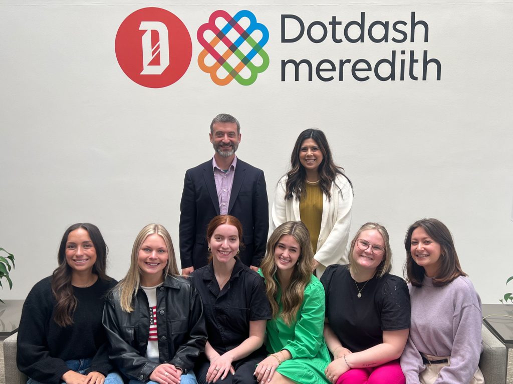 Six undergraduate students pose in the Dotdash Meredith offices with Michael Dahlstrom and Maria Charbonneaux.
