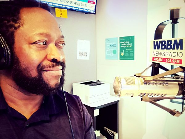 Tony Moton looking into a WBBM radio mic in studio