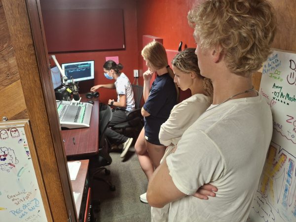 88.5 KURER Ames Alternative general manager Kamil Qureshi trains Greenlee School of Journalism and Communication students (left to right) Kalee Wise, Marijke Mendeszoon and Caleb Polking on radio board operation in the station's studio in the basement of Friley Hall dormitory.