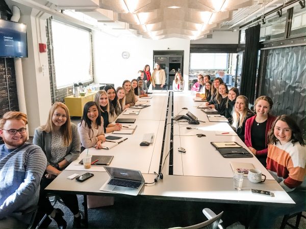 students gathered around a conference table