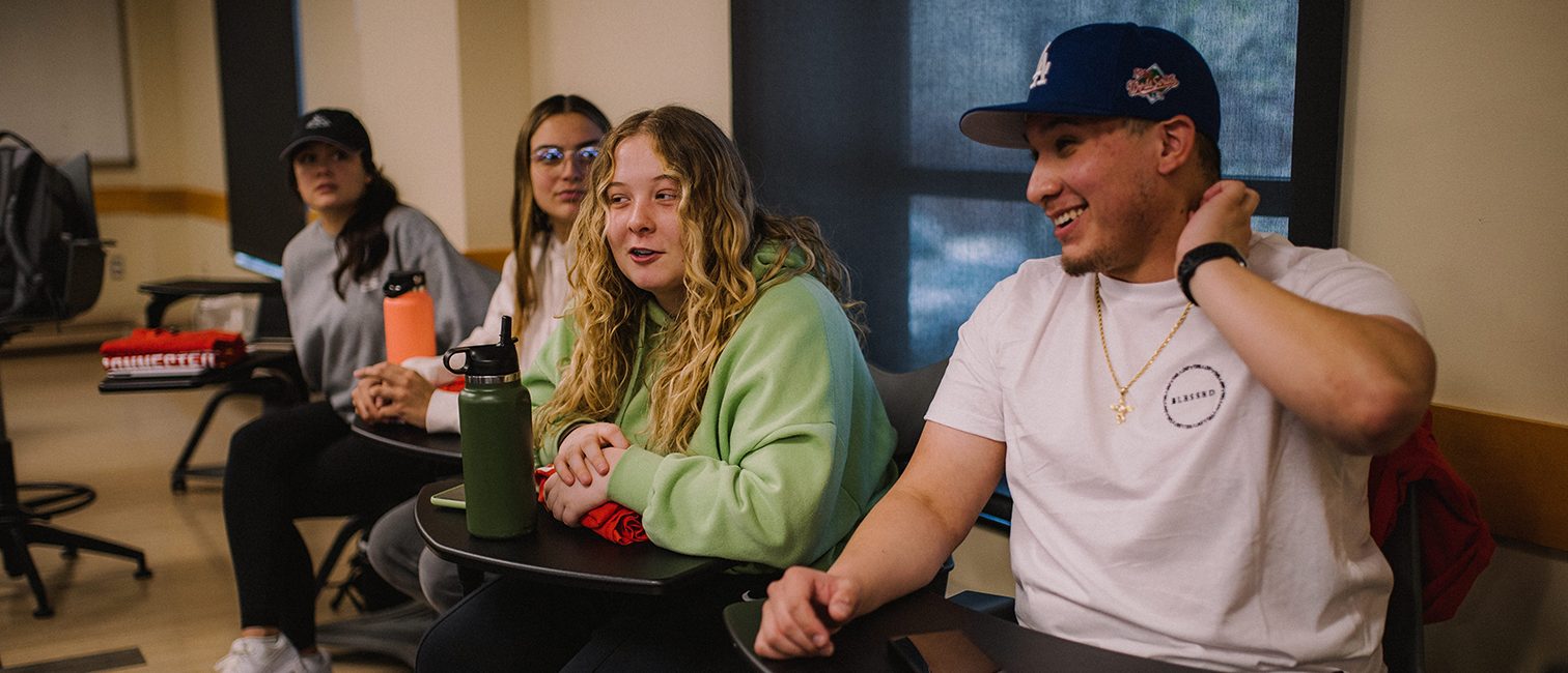 group of students smiling in a marketing class