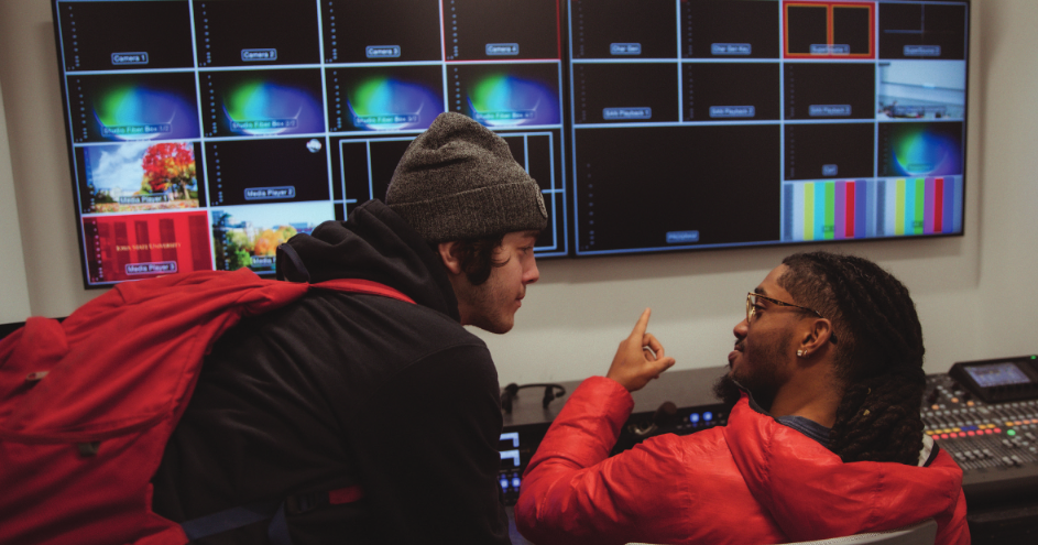 Two students doing multimedia production in a broadcast lab